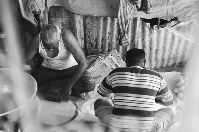 Two men working in a food stall in Pune