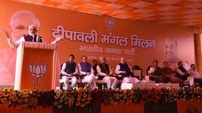 Narendra Modi and others on stage addressing audience at the Diwali Milan