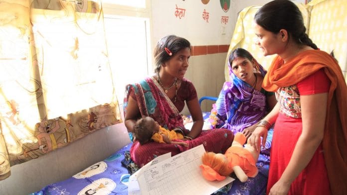 New mother talking to a nurse at the hospital