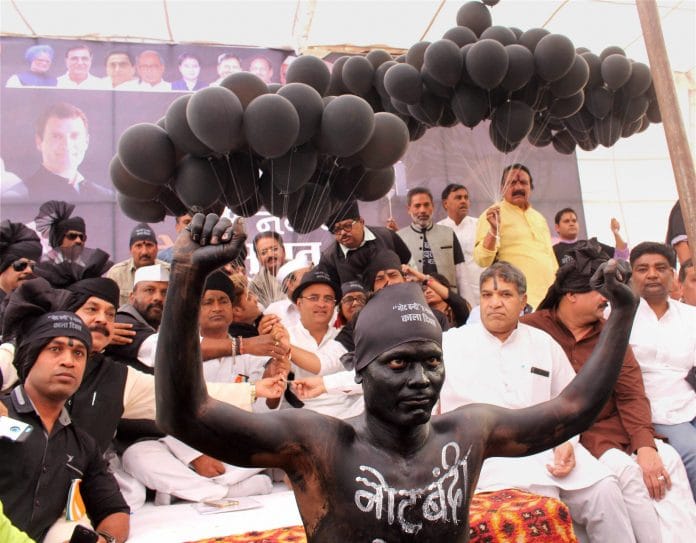A man painted black to protest demonetisation
