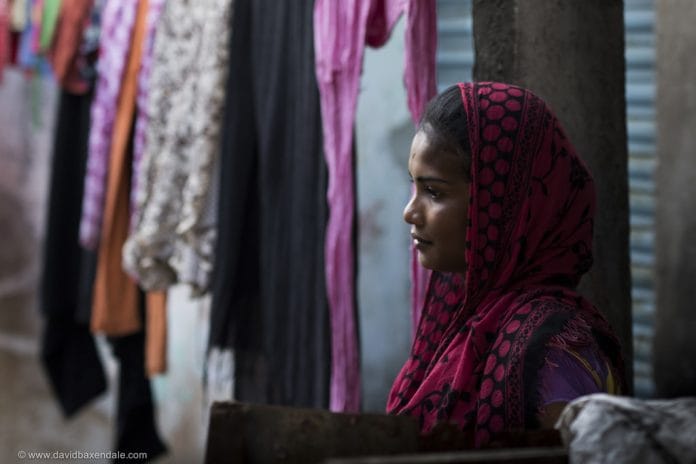 A woman near clothes hanging