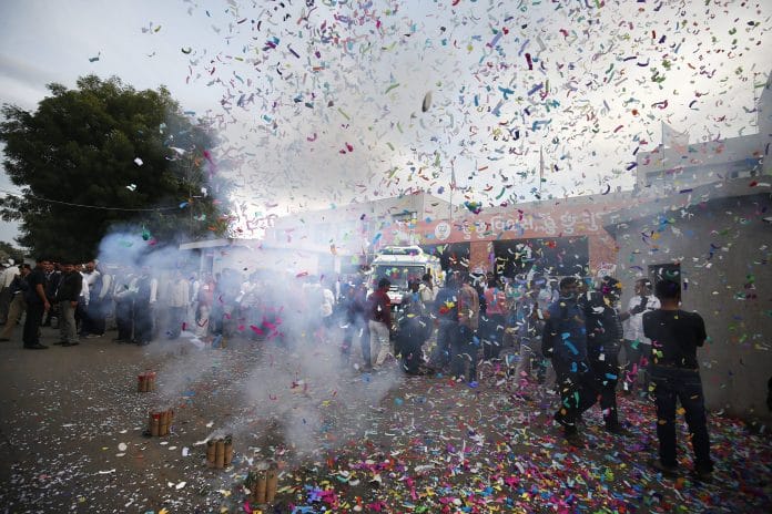 Supporters of BJP burn firecrackers to celebrate the party's victory