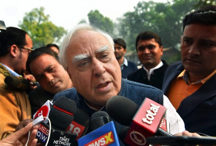Congress leader Kapil Sibal addresses the media on 2G outside the Parliament