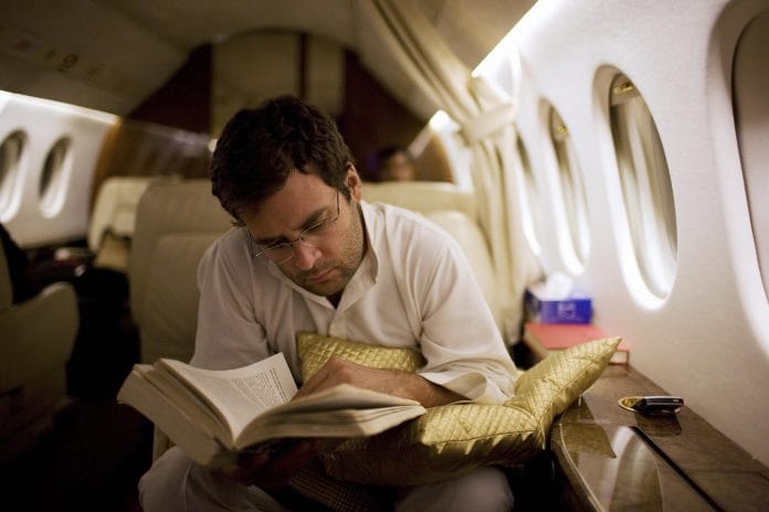 Congress President Rahul Gandhi reading on a plane