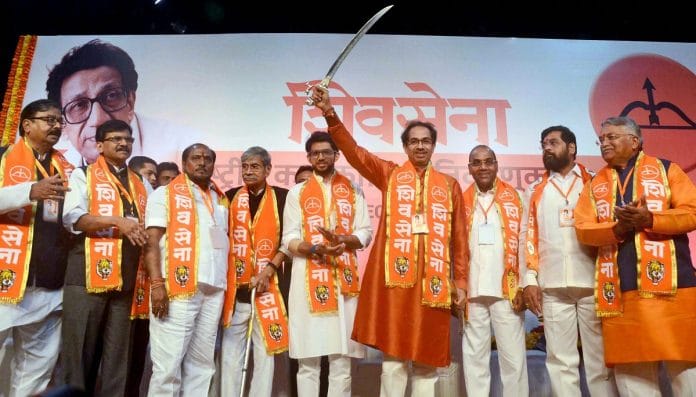 Shiv Sena President Uddhav Thackeray brandishes a sword at the party's national executive meeting at NSCI Worli in Mumbai