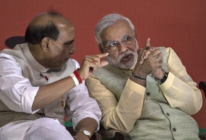 Prime Minister Narendra Modi, speaks with Home Minister Rajnath Singh.