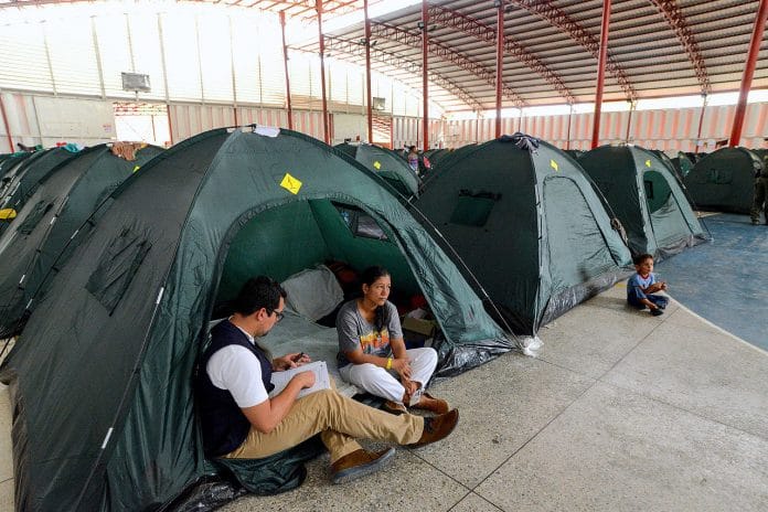 An aid worker talking to a Venezuelan refugee in Colombia, during an earlier migrant crisis. Photo used for representational purposes | Commons