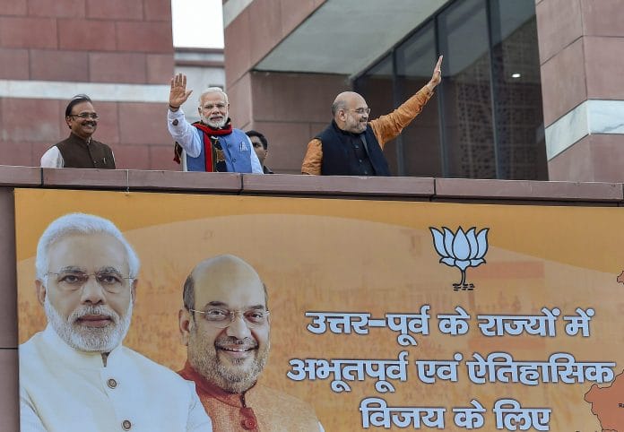 Prime Minister Narendra Modi and BJP President Amit Shah wave as they arrive at the party headquarters in New Delhi | Kamal Singh/PTI