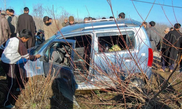 Shopian: Locals stand around the vehicle that was hit during a shoot-out at Pahoo in Shopian district of south Kashmir | PTI