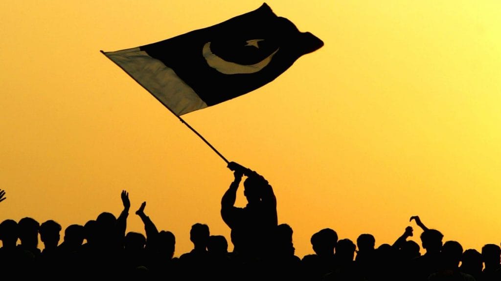 A man waves the flag of Pakistan