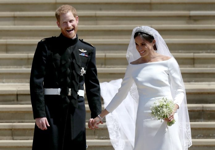 Prince Harry, Duke of Sussex and Meghan Markle, the Duchess of Sussex depart after their wedding ceremony at Windsor Castle on 19 May 2018 in Windsor, England