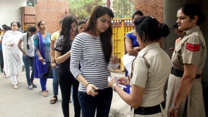 File image of UPSC candidates standing in queue for inspection by police personnel outside an exam centre in Gurugram | PTI