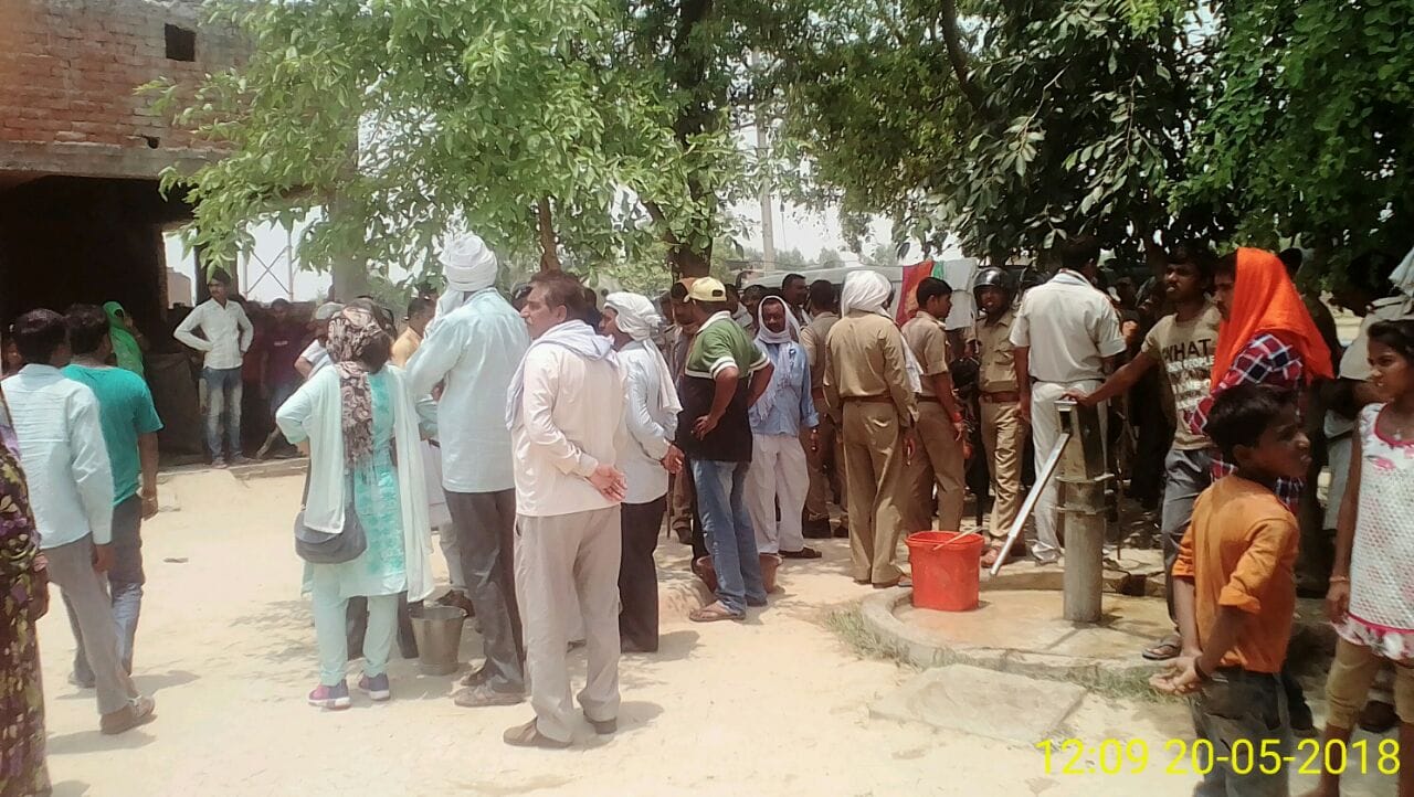 Pasi villagers watch as the encroachment settlement is demolished