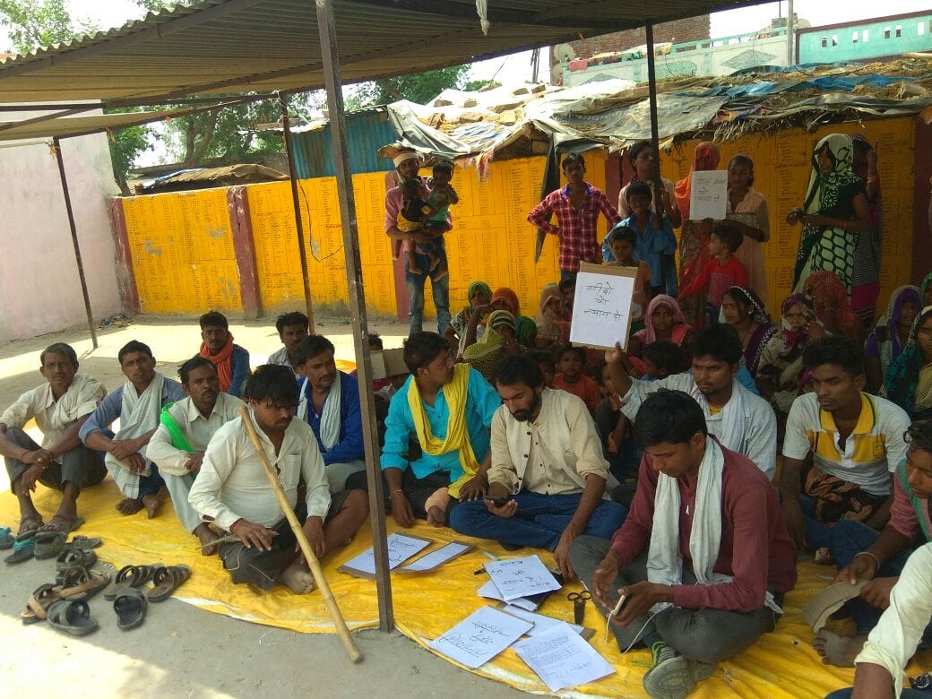 The Pasi community members whose homes burnt down, stage a protest outside the block district office Wednesday
