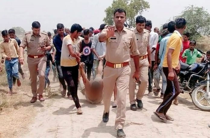 File photo of police escorting men dragging Qasim in Hapur, Uttar Pradesh, on 18 June 2023. | PTI