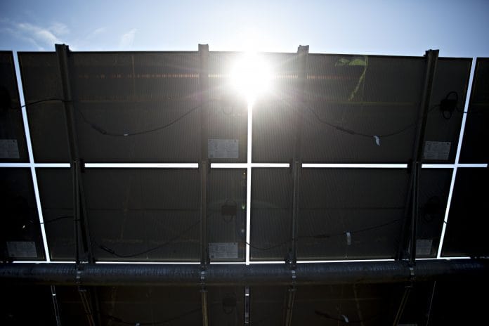 solar panels at a solar generating facility | Bloomberg