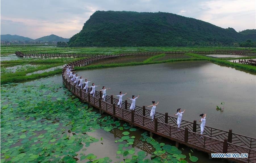 Women perform yoga to mark International Yoga Day in China |