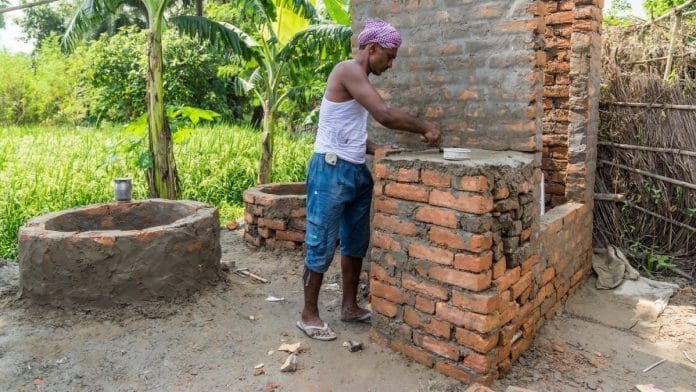 Man constructing toilet in a village in Muzaffarnagar, Bihar | Christopher Wilton-Steer/Aga Khan Development Network