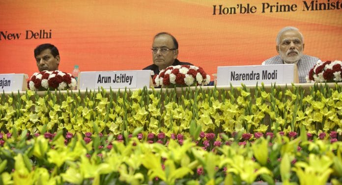 Former RBI governor Raghuram Rajan with Arun Jaitley and PM Narendra Modi | Kuni Takahashi/Bloomberg