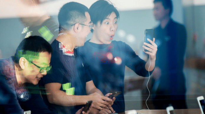 Chinese customers look at the new iPhone X at an Apple store | Getty images