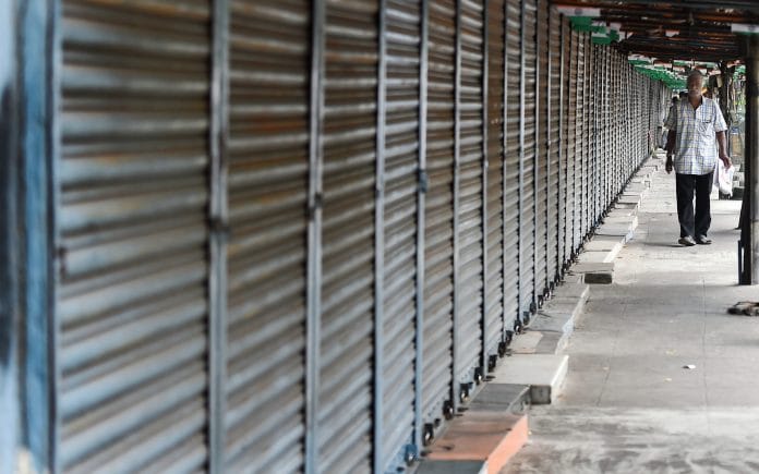 A man walks past closed shops in delhi | Representative Image | PTI