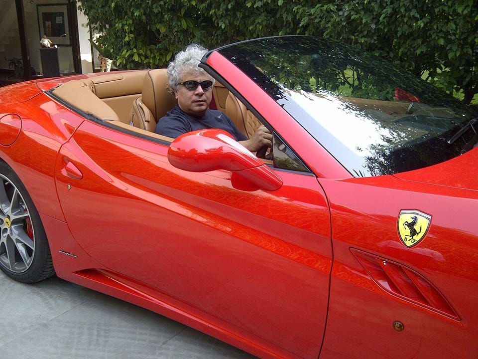 Suhel Seth in a red Ferrari