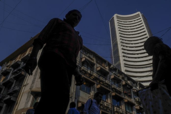 Pedestrians walk past the Bombay Stock Exchange building in Mumbai | Dhiraj Singh/Bloomberg