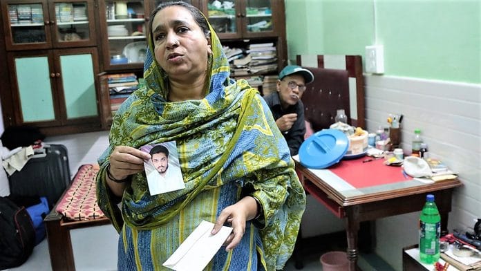 Najeeb’s mother Fatima Nafees and his father Nafees Ahmed show a photograph of their missing son in this file photo. | Manisha Mondal | ThePrint