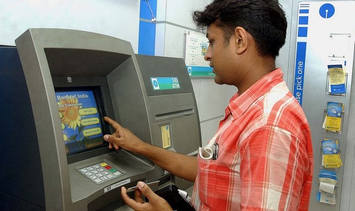 A customers uses a ATM machine in | STR/Bloomberg News