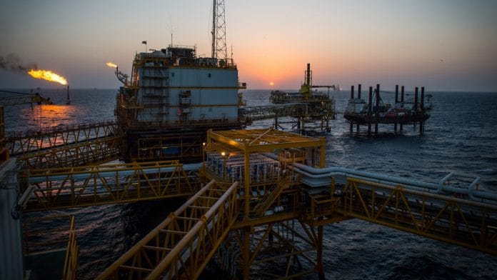 Gas flares burn from pipes aboard an offshore oil platform near Lavan island, Iran | Ali Mohammadi/Bloomberg