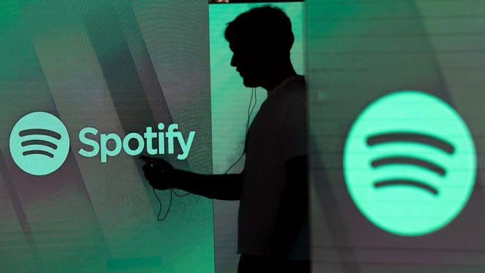 An illuminated screen bearing the Spotify Technology SA logo in London | Chris Ratcliffe/Bloomberg