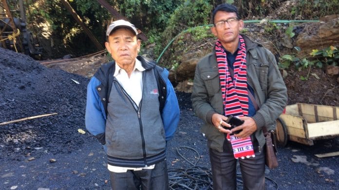 Ram Prasad Limbu (in cap) with his neighbour at the spot. Limbu’s son Assh Bahadur Limbu is trapped inside the Ksan coal mine
