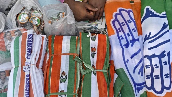 A vendor sells Congress souvenirs on a street in Bhopal, Madhya Pradesh