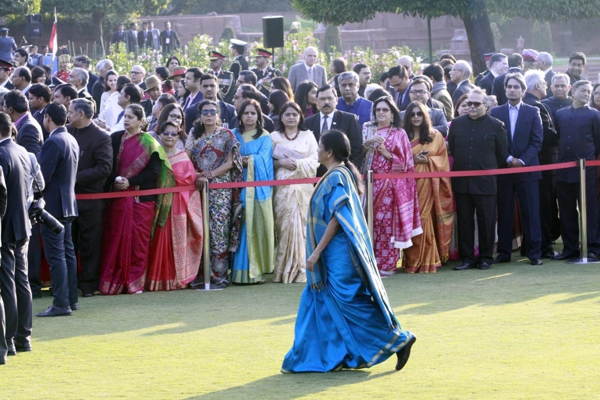 Defence minister Nirmala Sitharaman walks across the lawn as guests look on | Praveen Jain/ThePrint