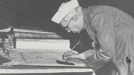 Jawaharlal Nehru signing the Constitution of India | Commons