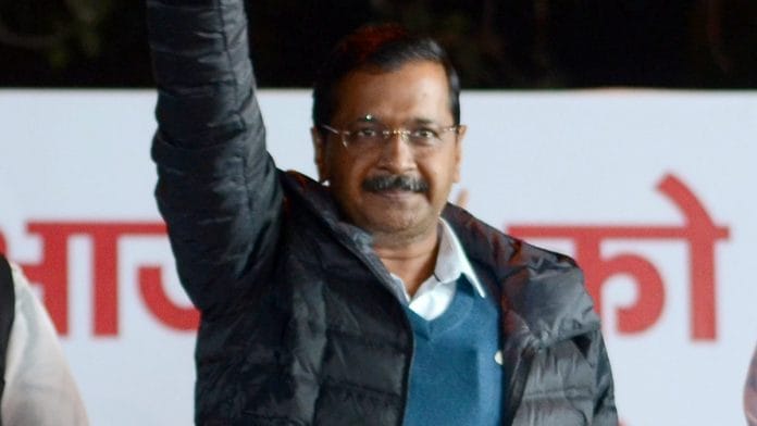 Delhi Chief Minister Arvind Kejriwal waves at his supporters during a public meeting, in the walled city area of New Delhi