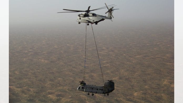 An Mi-26 helicopter airlifting a Chinook helicopter