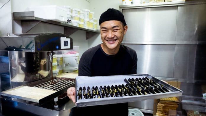 Ong Ning Geng of Chocolate Concierge presents a tray of chocolate | Nadirah Zakariya/Bloomberg