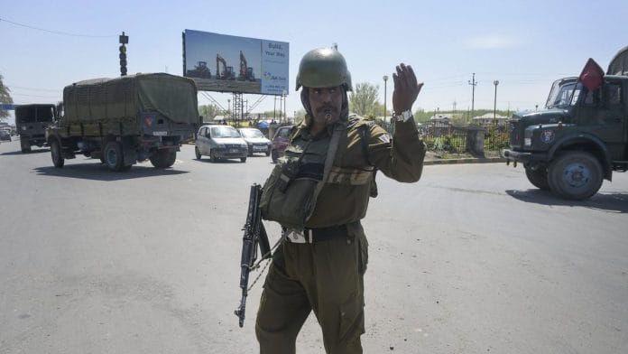 A security personnel stands guard on the Jammu-Srinagar-Baramulla national highway, on the outskirts of Srinagar | S. Irfan | PTI