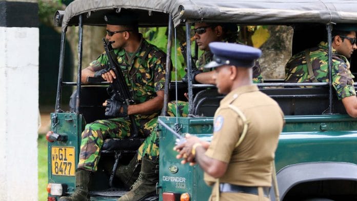 Special Task Force (STF) police officers sit in a vehicle arriving at the Parliament of Sri Lanka in Colombo