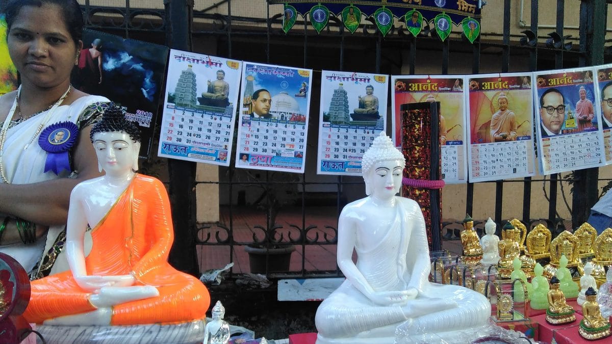 Calendars and statues of the Buddha and BR Ambedkar at a shop | Commons