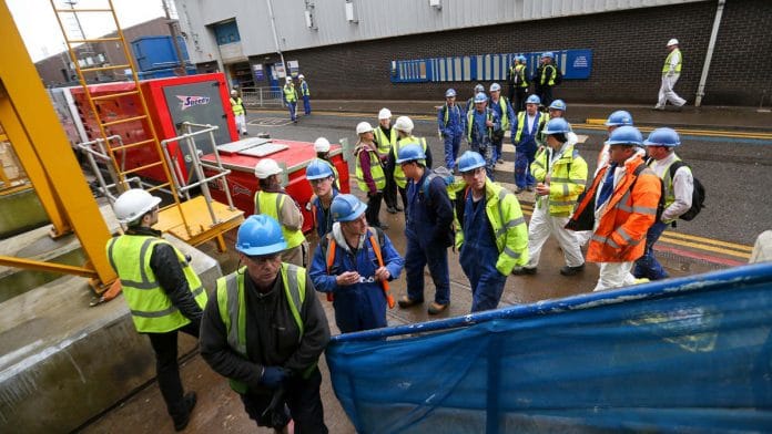 Workers at a busy shipping yard