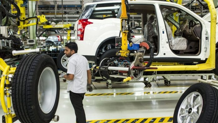 An employee fits a wheel in a car factory | Representational image | Photo: Udit Kulshrestha/Bloomberg