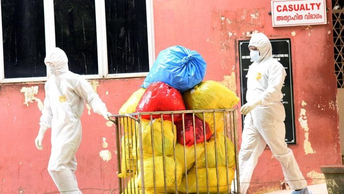 Hospital staff removes the waste of an isolation ward of Ernakulam Medical College, Kochi. | ANI Photos