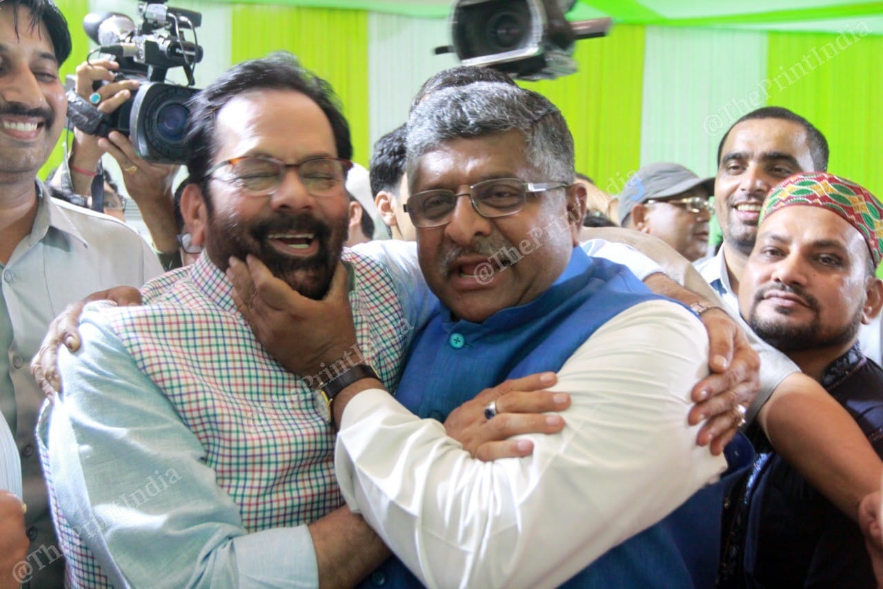 Mukhtar Abbas Naqvi gives Law Minister Ravi Shankar Prasad a hearty welcome | Photo: Praveen Jain | ThePrint