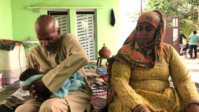 Kamlesh (L) and Subhash with their months-old granddaughter. | Photo: Jyoti Yadav | ThePrint