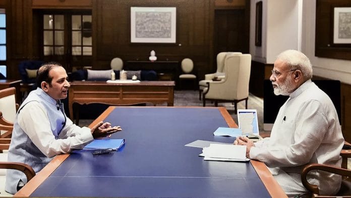 Indian High Commissioner to Pakistan Ajay Bisaria (L) with PM Narendra Modi (R)