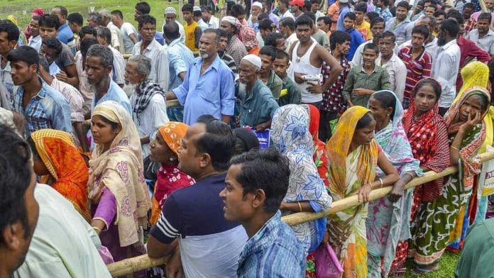 People wait to check their names on the final draft of the state's