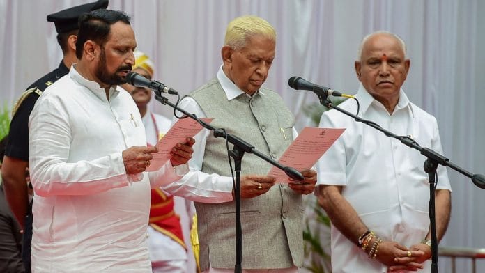 Karnataka Governor Vajubhai Vala administers the oath of office and secrecy to Laxman Savadi during the swearing-in ceremony of Karnataka BJP Government, at Raj Bhavan in Bengaluru | PTI
