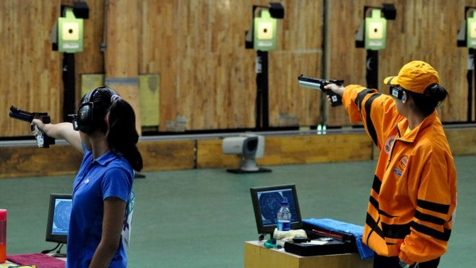 India's Heena Sidhu (L) and Malaysia's Ng Pei Chin Bibiana (R) during the shooting event at 2010 Commonwealth Games in New Delhi. |